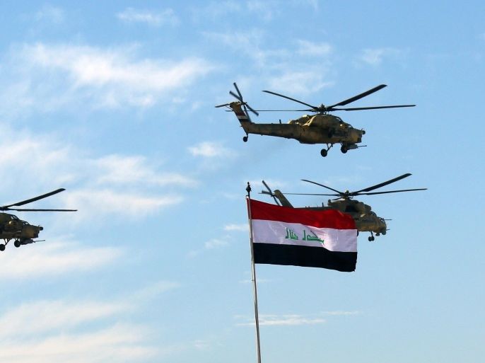 Iraqi Army helicopters fly in formation during the Army Day celebrations in Baghdad, Iraq, Tuesday, Jan. 6, 2015. The Iraqi Army was activated on Jan. 6, 1921 while under British rule. (AP Photo/Hadi Mizban)