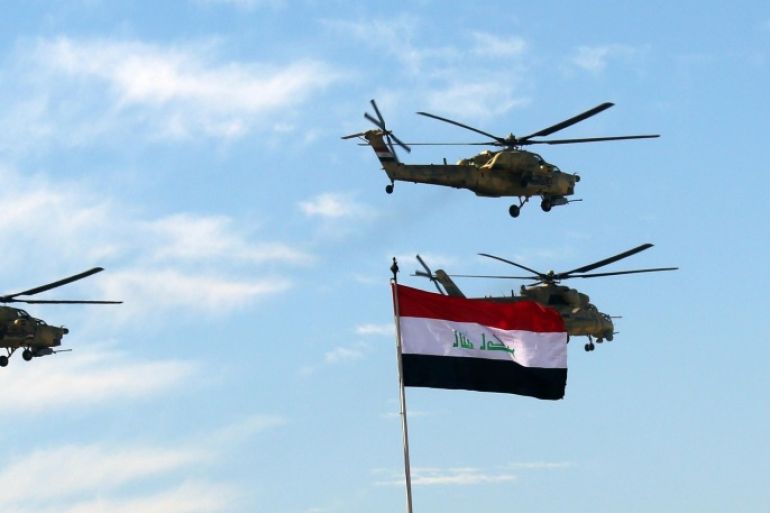 Iraqi Army helicopters fly in formation during the Army Day celebrations in Baghdad, Iraq, Tuesday, Jan. 6, 2015. The Iraqi Army was activated on Jan. 6, 1921 while under British rule. (AP Photo/Hadi Mizban)
