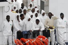 Migrants stand on the "Fiorillo" Coast Guard vessel as they arrive at the Porto Empedocle harbour February 14, 2015. Two commercial ships and an Italian coastguard vessel have rescued about 700 migrants from overcrowded boats near the Libyan coast. REUTERS/Antonio Parrinello (ITALY - Tags: DISASTER SOCIETY IMMIGRATION MARITIME MILITARY)
