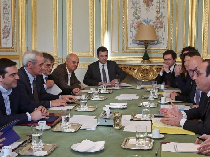 French President Francois Hollande, right, speaks with Greek prime minister Alexis Tsipras, left, during their meeting at the Elysee Palace in Paris, Wednesday Feb. 4, 2015. In a short trip to Brussels before heading to France, Tsipras was welcomed at the European Commission, one of the three main institutions overseeing Greece's finances, by President Jean-Claude Juncker. (AP Photo/Remy de la Mauviniere/Pool)