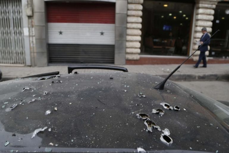 A damaged car is seen following rocket attacks that occurred yesterday by Islam Army insurgents on Damascus February 6, 2015. Rocket attacks killed 10 people in Damascus on Thursday and wounded at least 50, a monitoring group said, in the second heavy bombardment by Islam Army insurgents in less than two weeks. REUTERS/ Omar Sanadiki (SYRIA - Tags: CIVIL UNREST POLITICS CONFLICT)