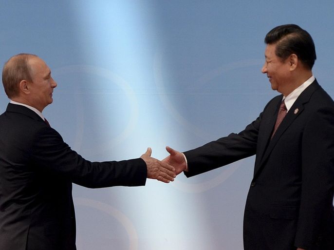 FILE - In this May 21, 2014 file photo, Russian President Vladimir Putin, left, is greeted by Chinese President Xi Jinping before the opening ceremony at the fourth Conference on Interaction and Confidence Building Measures in Asia (CICA) summit in Shanghai, China. Moscow is cozying up to its old rival China. China is holding hands with Seoul. Tokyo is striking deals with Pyongyang. In the ever-shifting game of Asian alliances, where just about everybody has a dispute over something or can actually remember a shooting war with their neighbors, past grudges run deep. But expedience and pragmatism often run deeper. (AP Photo/Mark Ralston, Pool, File)