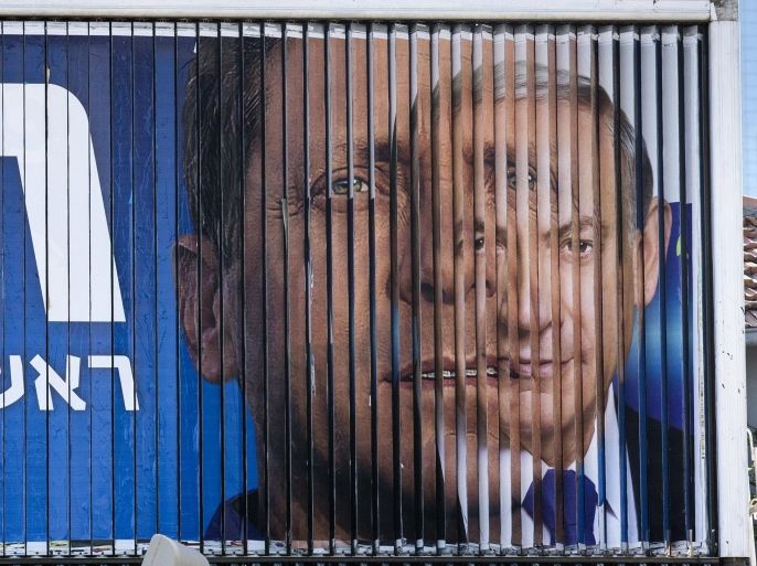 A giant campaign billboard rotates showing Israeli Prime Minister and Likud party's candidate Benjamin Netanyahu (R) and Israeli MP Labour Party leader and co-leader of the Zionist Union party, Isaac Herzog on March 14, 2015 in the coastal Israeli city of Tel Aviv. AFP PHOTO / JACK GUEZ