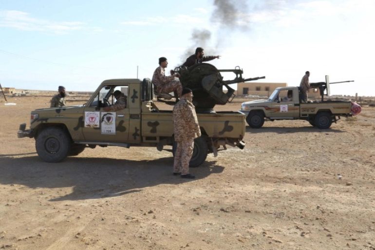 Libyan Army Forces belonging to Libya's rival government, that are part of the Alshorooq (Libya Dawn) operation to free oil ports, are seen on the outskirts of Al Sidra oil port December 14, 2014. Picture taken December 14, 2014. REUTERS/Stringer (LIBYA - Tags: POLITICS CONFLICT MILITARY)