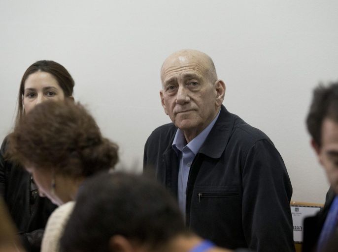 Former Israeli Prime Minister Ehud Olmert inside the District Court in Jerusalem 30 March 2015 while awaiting the verdict in the Talansky retrial. The court convicted Olmert thus reversing its earlier acquittal. The retrial followed new evidence by a former top Olmert aide-turned state witness which was not available for his original trial in July 2012. The court ruled that the former premier illegally received and concealed funds in envelopes from New York businessman Morris Talansky in the late 1990s and 2000s.