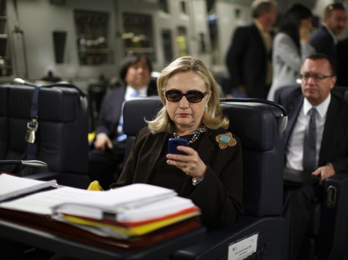 FILE - In this Oct. 18, 2011, file photo, then-Secretary of State Hillary Rodham Clinton checks her Blackberry from a desk inside a C-17 military plane upon her departure from Malta, in the Mediterranean Sea, bound for Tripoli, Libya. Clinton used a personal email account during her time as secretary of state, rather than a government-issued email address, potentially hampering efforts to archive official government documents required by law. Clinton's office said nothing was illegal or improper about her use of the non-government account and that she believed her business emails to State Department and other .gov accounts would be archived in accordance with government rules. (AP Photo/Kevin Lamarque, Pool, File)