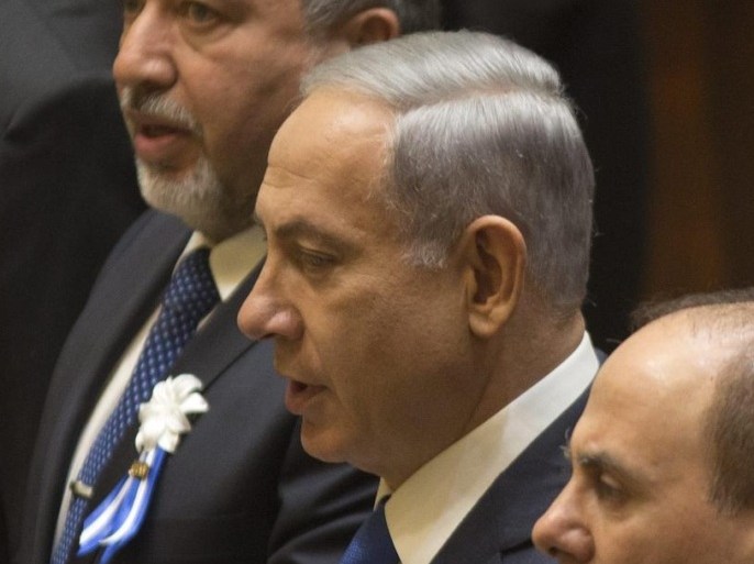 Elected Irsaeli Prime Minister Benjamin Netanyahu (2-L) stands as his name is called during the swearing-in ceremony held at the Knesset, (Parliament), in Jerusalem, 31 March 2015. One hundred and twenty members of the 20th Knesset, who were elected on 17 March 2015, gathered for the ceremony.