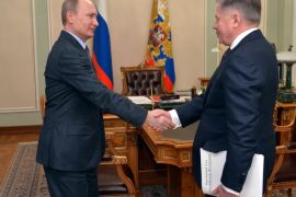 Russian President Vladimir Putin shakes hands with the Supreme Court Chairman Vyacheslav Lebedev, right, in the Novo-Ogaryovo residence outside Moscow, Russia, Friday, March 13, 2015. The Kremlin says Russian President Vladimir Putin, who has been out of public view for more than a week, is to meet on Monday with the president of Kyrgyzstan. (AP Photo/RIA Novosti, Alexei Druzhinin, Presidential Press Service)