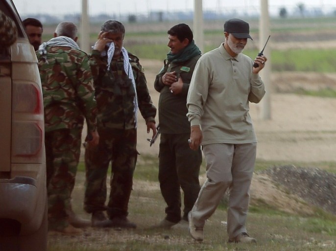 Iranian Revolutionary Guard Commander Qassem Soleimani uses a walkie-talkie at the frontline during offensive operations against Islamic State militants in the town of Tal Ksaiba in Salahuddin province March 8, 2015. Picture taken March 8, 2015. REUTERS/Stringer (IRAQ - Tags: CIVIL UNREST CONFLICT POLITICS)
