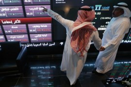 Investors talk as they monitor screens displaying stock information at the Saudi Stock Exchange (Tadawul) in Riyadh November 12, 2014. Shares in Saudi Arabia's biggest lender, National Commercial Bank, jumped their daily 10 percent limit upon listing on Wednesday after a $6 billion IPO, the largest ever in the Arab world and the second-biggest globally this year. REUTERS/Faisal Al Nasser (SAUDI ARABIA - Tags: BUSINESS)