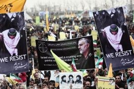 Iranian demonstrators hold a portrait of Iranian commander Major General Qassem Suleimani (C), who has been advising Iraqi military leaders fighting Islamic jihadists,during a rally to mark the 36th anniversary of the Islamic revolution in Tehran's Azadi Square (Freedom Square) on February 11, 2015. President Hassan Rouhani delivered a speech saying said the world needs Iran to help stabilise the troubled Middle East, in remarks pointing to wider ramifications of a deal over its disputed nuclear programme. AFP PHOTO/BEHROUZ MEHRI