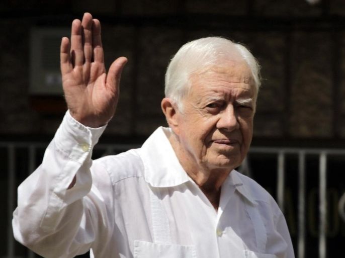 Former U.S. President Jimmy Carter waves to reporters after a visit to the headquarters of Cuba's Jewish community in Havana March 28, 2011. Carter, returning to Cuba for the first time since a groundbreaking 2002 trip, began a three-day visit on Monday to discuss troubled U.S.-Cuba relations and the fate of imprisoned U.S. aid contractor Alan Gross.