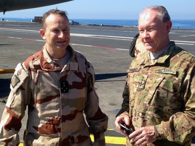 Gen. Martin Dempsey, chairman of the U.S. Joint Chiefs of Staff, right, confers with his French counterpart, Gen. Pierre de Villiers, aboard the French aircraft carrier Charles de Gaulle in the Persian Gulf on Sunday, March 8, 2015. Dempsey says some Iraqi army units in line for U.S.-led training to fight the Islamic State group are showing up ill-prepared. (AP Photo/Bob Burns)