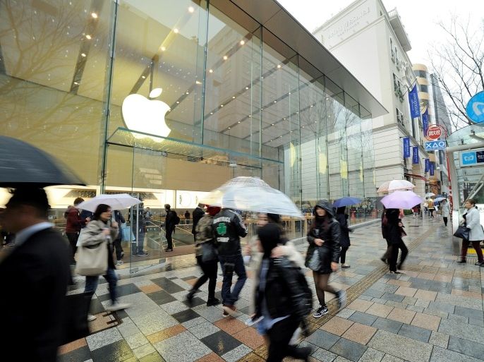 TOKYO, JAPAN - MARCH 19 : Shoppers are seen walking past the Apple store at the high-end shopping district of Omotesando in Tokyo, Japan, on March 19, 2015. Apple stores are preparing to launch the new Apple Watch on April 24th.