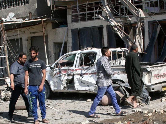 Iraqis gather at the scene of a car bomb attack in Habibiya district, eastern Baghdad, Iraq, 23 March 2015. A wave of bombings and mortar attacks in eastern Baghdad have killed at least 19 people and injured scores more, security and medical officials said.