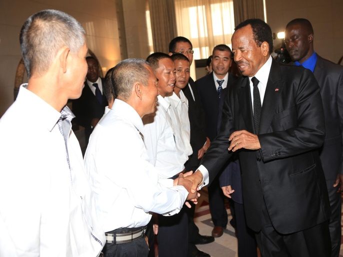 In this photo taken Monday, Oct. 13, 2014, Cameroonian President, Paul Biya, right, shake hands with Chinese former hostages, during a reception in Yaounde, Cameroon. Biya received 10 Chinese and 17 Cameroonians, who were freed from captivity last week after spending some months as hostages, held by armed men thought to belong to the militant rebel Islamist group Boko Haram in Nigeria which has been increasingly making incursions into Cameroon. (AP Photo/ Fabrice Ngon)