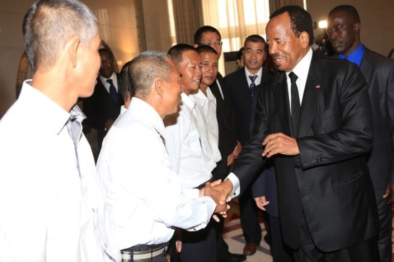 In this photo taken Monday, Oct. 13, 2014, Cameroonian President, Paul Biya, right, shake hands with Chinese former hostages, during a reception in Yaounde, Cameroon. Biya received 10 Chinese and 17 Cameroonians, who were freed from captivity last week after spending some months as hostages, held by armed men thought to belong to the militant rebel Islamist group Boko Haram in Nigeria which has been increasingly making incursions into Cameroon. (AP Photo/ Fabrice Ngon)