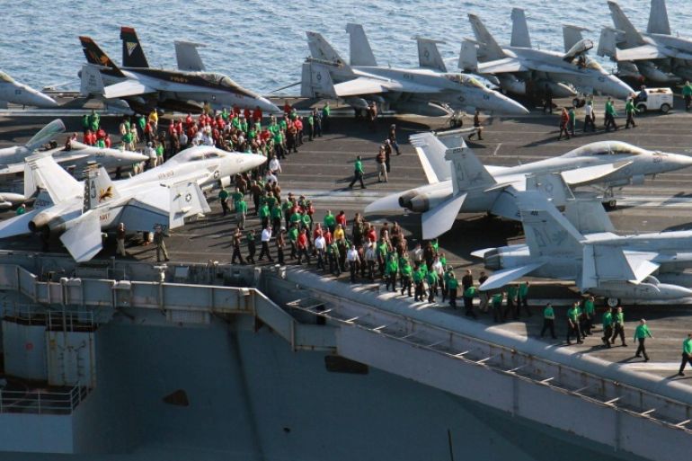In this photo taken Friday, Oct. 10, 2014, U.S. sailors conduct a drill on the aircraft carrier USS George H.W. Bush in the Persian Gulf. On Thursday, Oct. 16, the U.S. conducted 14 airstrikes, hitting buildings controlled by the Islamic State group, sniping positions and a heavy machine gun, according to a statement issued by the U.S. military's central command. Over the last two weeks, U.S airstrikes in support of Kurdish fighters in the embattled border town of Kobani have killed hundreds of Islamic State fighters in Syria and Iraq, said Rear Adm. John Kirby. (AP Photo/Brian Stephen, U.S. Navy)
