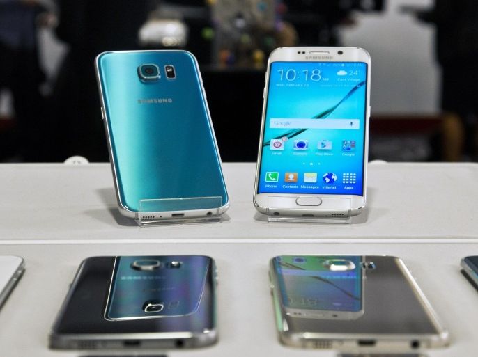 Two new Samsung phones, Galaxy S6, top left, and Galaxy S6 Edge, top right, are on display with choice of color selections at a special press preview, Monday, Feb. 23, 2015, in New York. Samsung officially unveiled the stylish new phones on Sunday, March 1, 2015, the eve of this week's Mobile World Congress wireless show in Barcelona, Spain. (AP Photo/Bebeto Matthews)