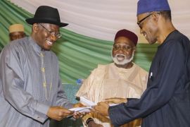 A photograph made available 27 March 2015 shows Nigerian All Progressive Congress (APC) presidential candidate Muhammadu Buhari (R) and incumbent Nigerian president Goodluck Jonathan (L) of the Peoples Democratic Party (PDP) exchanging a signed peace deal brokered by General Abdulsalami Abubakar (C) in Abuja, Nigeria 26 March 2015. The peace deal sees the two top contenders promising to respect the outcome of a the polls and to encourage their supporters to refrain from violence. Former Nigerian General Muhammadu Buhari is the main contender against incumbent President Goodluck Jonathan who is seeking a second term in office in the Nigerian general elections taking place on 28 March 2015 after being delayed for over a month.