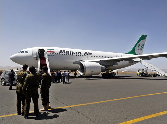 epa04642933 Members of the Houthi militia look on as people disembark the first Iranian Mahan Airways plane to land at the International Airport arrives, Sana?a, Yemen, 01 March 2015. According to reports the Houthis-controlled Yemeni Aviation Authority and Iranian Aviation Authority signed 27 February an agreement to operate 28 flights a week between the two countries, while Gulf and foreign airlines have suspended flights to restive country following the Houthi takeover of the capital Sana?a and large parts of the country September 2014. EPA/YAHYA ARHAB