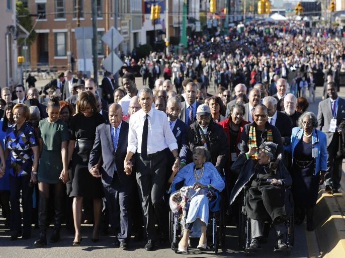 U.S. President Barack Obama (center L) participates in a march across the Edmund Pettus Bridge in Selma, Alabama, March 7, 2015. With a nod to ongoing U.S. racial tension and attempts to limit voting rights, Obama declared the work of the Civil Rights Movement advanced but unfinished on Saturday on a visit to the Alabama bridge that spawned a landmark voting law. REUTERS/Jonathan Ernst (UNITED STATES - Tags: POLITICS ANNIVERSARY SOCIETY)