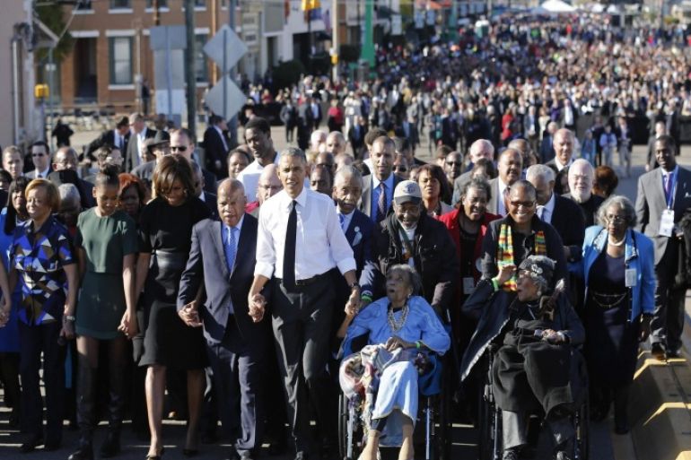U.S. President Barack Obama (center L) participates in a march across the Edmund Pettus Bridge in Selma, Alabama, March 7, 2015. With a nod to ongoing U.S. racial tension and attempts to limit voting rights, Obama declared the work of the Civil Rights Movement advanced but unfinished on Saturday on a visit to the Alabama bridge that spawned a landmark voting law. REUTERS/Jonathan Ernst (UNITED STATES - Tags: POLITICS ANNIVERSARY SOCIETY)