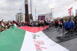 Participants at the 14th World Social Forum (WSF) hold an enormous Palestinaian flag during the closing of the forum's events, Tunis, Tunisia, 28 March 2014. The WSF opened in Tunisia on 24 March, with trade union members and political activists participating in the five-day events, concluding with events on the last day in solidarity with Palestinians.