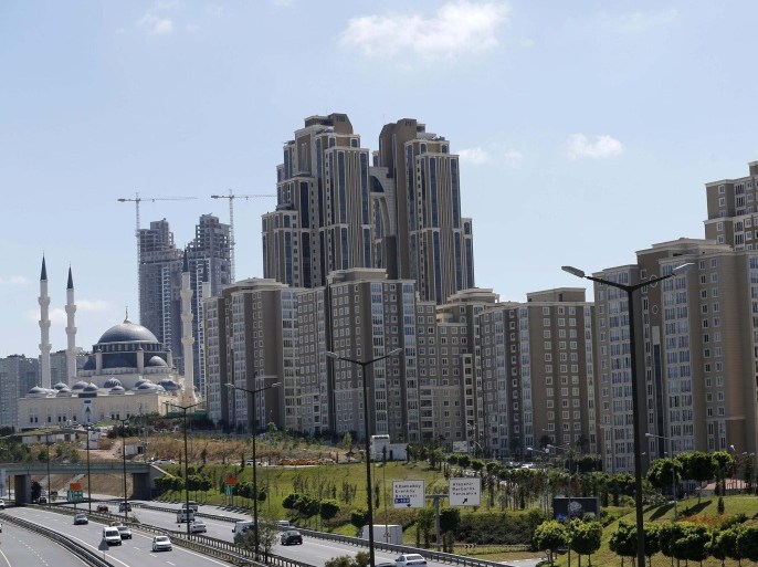 Residential towers are seen next to the newly built Mimar Sinan mosque (L) in Atasehir on the Asian side of Istanbul in this September 4, 2012 file photo. The developer of a five-tower luxury compound perched on the edge of the new financial district on Istanbul's Asian side is putting the finishing touches to a complex that will boast eco-friendly apartment blocks, swimming pools and lush green parks. It is the sort of development that overseas property buyers in Turkey, mainly from Europe, have usually shied away from, investing instead in holiday homes along the country's Mediterranean and Aegean shores. But a new wave of wealthy investors from the Middle East and Russia is increasingly eyeing luxury developments in bustling Istanbul, lured by a relaxation in property laws, relatively cheap prices and a thriving economy. Picture taken September 4, 2012. To match TURKEY-PROPERTY/(MIDEAST MONEY) REUTERS/Murad Sezer (TURKEY - Tags: BUSINESS REAL ESTATE SOCIETY WEALTH)