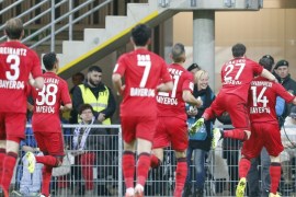 Leverkusen's Kyriakos Papadopoulos from Greece, right, celebrates with teammates after scoring during the German first division Bundesliga soccer match between SC Paderborn and Bayer 04 Leverkusen in Paderborn, Germany, Sunday, March 8, 2015. (AP Photo/Frank Augstein)