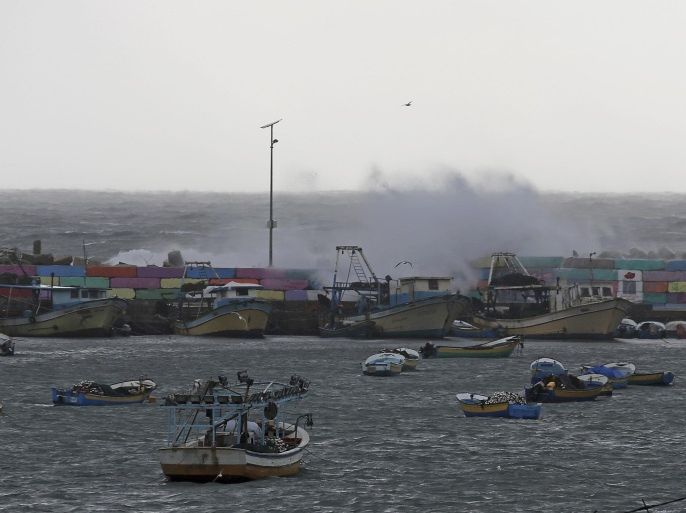 Waves of the Mediterranean Sea hit Palestinian boats parked in the fishermen's port during rainy weather in Gaza City, in the northern Gaza Strip, Friday, Feb. 20, 2015. A heavy winter storm descended on parts of the Middle East on Friday. (AP Photo/Adel Hana)