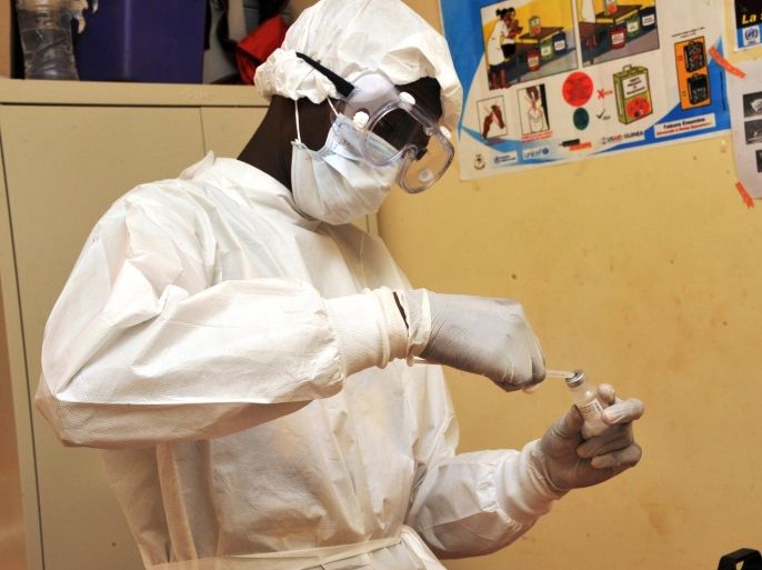 A health worker prepares a vaccination on March 10, 2015 at a health center in Conakry during the first clinical trials of the VSV-EBOV vaccine against the Ebola virus. The World Health Organization (WHO) said on March 5 that clinical trials launched on March 7 in Guinea marked the last step before the vaccine is available on the market. AFP PHOTO / CELLOU BINANI