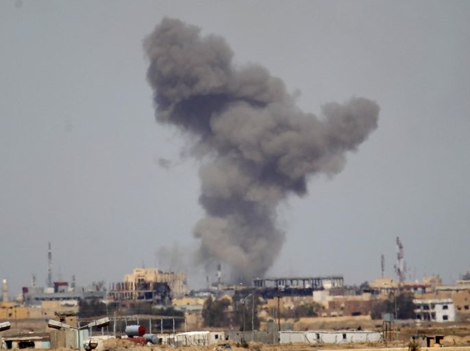 A plume of smoke rises above a building during an air strike in Tikrit March 27, 2015. U.S. and coalition forces conducted 10 air strikes against Islamic State fighters in Iraq during a 24-hour period, while U.S. forces led six air strikes in Syria, the U.S. military said on Friday. Three of the strikes in Iraq were near Tikrit, destroying vehicles and a potential car bomb. REUTERS/Thaier Al-Sudani