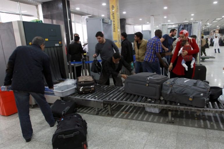 Travelers pass through security at Sanaa International Airport as hundreds of foreigners were evacuated from the Yemeni capital due to security reasons on March 28, 2015 after the third day of Saudi-led coalition airstrikes against Shiite Huthi rebels. AFP PHOTO / MOHAMMED HUWAIS