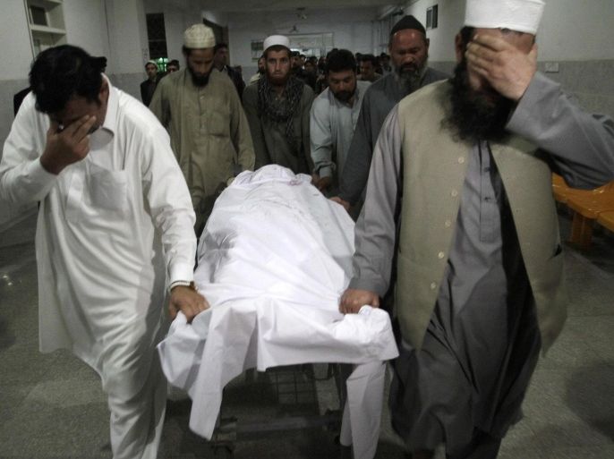 ATTENTION EDITORS - VISUAL COVERAGE OF SCENES OF INJURY OR DEATHRelatives move the body of Samiullah Afridi, who was killed by unidentified gunmen, at a hospital in Peshawar March 17, 2015. According to local media, unidentified gunmen opened fire on a vehicle killing Afridi, a defence lawyer who was pursuing the case of Shakil Afridi who had been jailed after helping the CIA find al-Qaida chief Bin Laden by running a fake vaccination campaign. REUTERS/Khuram Parvez (PAKISTAN - Tags: POLITICS CRIME LAW) TEMPLATE OUT