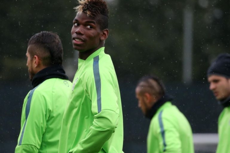 Juventus' French midfielder Paul Pogba takes part in a training session on the eve of the last 16, second-leg UEFA Champions League football match Borussia Dortmund Vs Juventus on March 17, 2015 at the 'Juventus Training Center' in Vinovo, near Turin. AFP PHOTO / MARCO BERTORELLO