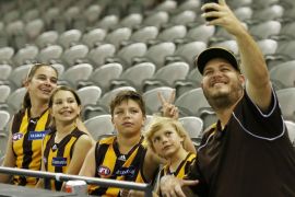 MELBOURNE, AUSTRALIA - MARCH 19: A Hawks family take a selfie during the NAB Challenge AFL match between St Kilda Saints and Hawthorn Hawks at Etihad Stadium on March 19, 2015 in Melbourne, Australia.