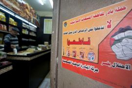 A poster calling people to boycott Israeli products is seen on a shop door in the West Bank City of Ramallah, Wednesday, Feb. 11, 2015. Activists from Palestinian President Mahmoud Abbas' Fatah movement have launched a campaign in the West Bank, calling on people to boycott products made by six major Israeli food companies. The poster reads in Arabic, "Campaign to take the initiative to boycott the Israel products, Do not pay for the bullets that kill our children, We want the occupation to lose." (AP Photo/Majdi Mohammed)