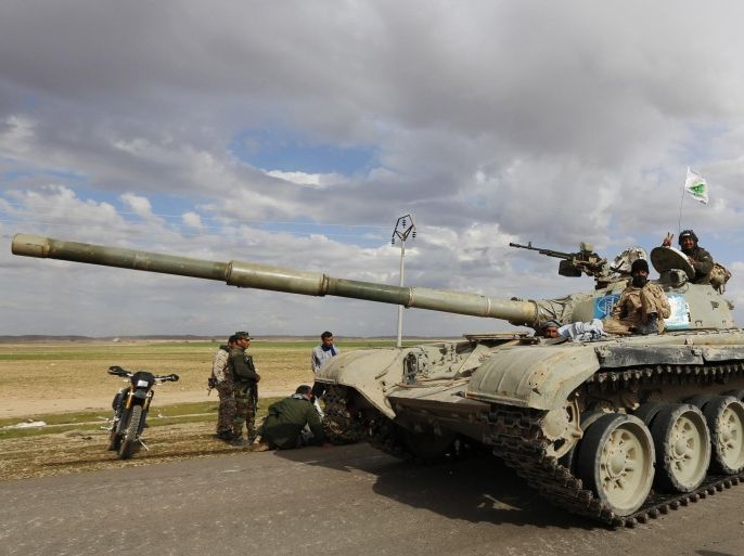 Iraqi security forces and Shi'ite Fighters sit on a tank, in the town of Hamrin, in the Salahuddin province March 3, 2015. Thousands of Iraqi soldiers and Shi'ite militiamen sought to seal off Islamic State fighters in Tikrit and nearby towns on Tuesday, the second day of Iraq's biggest offensive yet against a stronghold of the Sunni militants. REUTERS/Thaier Al-Sudani (IRAQ - Tags: POLITICS CONFLICT MILITARY CIVIL UNREST)