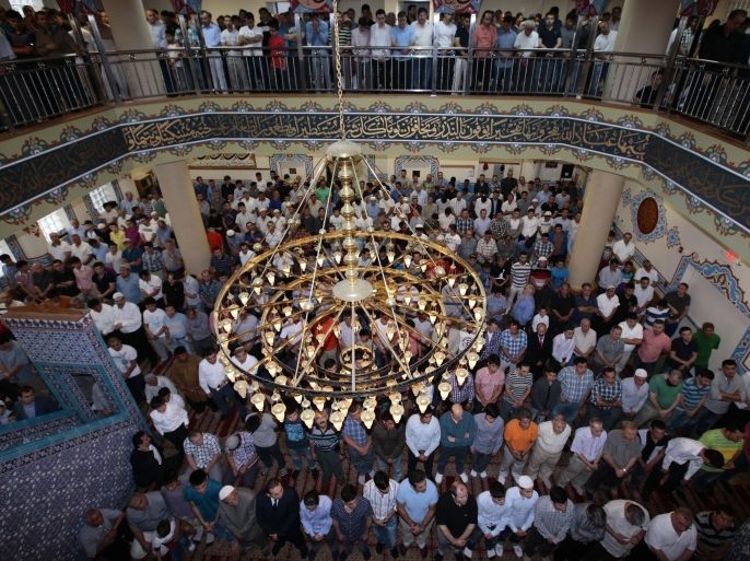 NEW YORK, NY - JULY 28: Muslims living in New York City perform Eid al-Fitr prayer at Eyup Sultan Mosque on July 28,2014. Eid al-Fitr also known Feast of Breaking the Fast, is religious holiday celebrated by Muslims worldwide that marks the end of Ramadan, the Islamic holy month of fasting.
