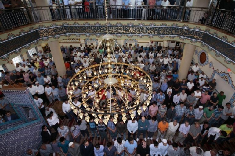 NEW YORK, NY - JULY 28: Muslims living in New York City perform Eid al-Fitr prayer at Eyup Sultan Mosque on July 28,2014. Eid al-Fitr also known Feast of Breaking the Fast, is religious holiday celebrated by Muslims worldwide that marks the end of Ramadan, the Islamic holy month of fasting.
