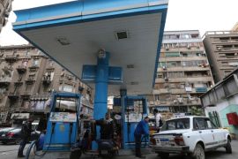 People are seen at a petrol station in Cairo, January 13, 2015. Reuters photographers from Mali to Mexico have shot a series of pictures of fuel stations. Whether it is plastic bottles by the roadside in Malaysia or a futuristic forecourt in Los Angeles, fuel stations help define our world. Oil prices steadied above $48 a barrel on Tuesday, recovering from earlier losses as the dollar weakened against the euro. Oil prices have dropped nearly 60 percent since peaking in June 2014 on ample global supplies from the U.S. shale oil boom and a decision by OPEC to keep its production quotas unchanged. REUTERS/Mohamed Abd El Ghany (EGYPT - Tags: TRANSPORT BUSINESS COMMODITIES ENERGY)ATTENTION EDITORS: PICTURE 15 OF 26 FOR WIDER IMAGE PACKAGE 'AT THE PUMP - THE WORLD FILLS UP' SEARCH 'WORLD FILLS UP' FOR ALL IMAGES