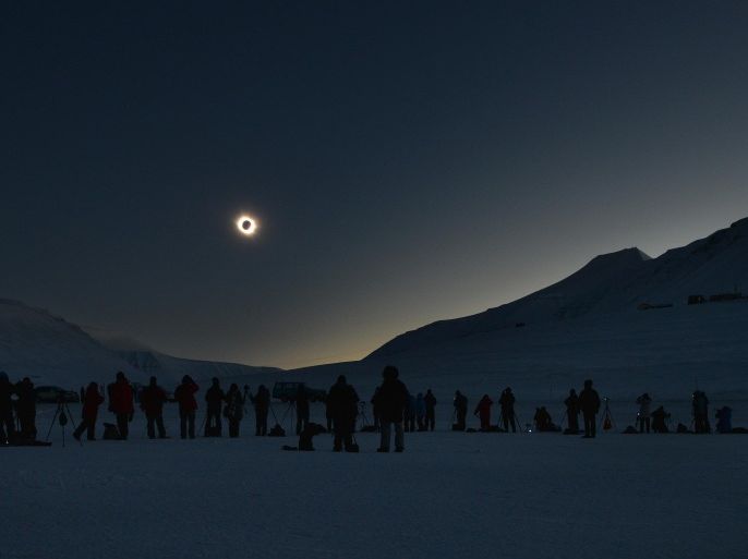People watch a total solar eclipse from Longyearbyen, Svalbard, an archipeligo administered by Norway on March 20, 2015. Thousands gathering here as the only land the total eclipse will be seen from is on Svalbard and the Faoroe Islands off Iceland. AFP PHOTO / STAN HONDA