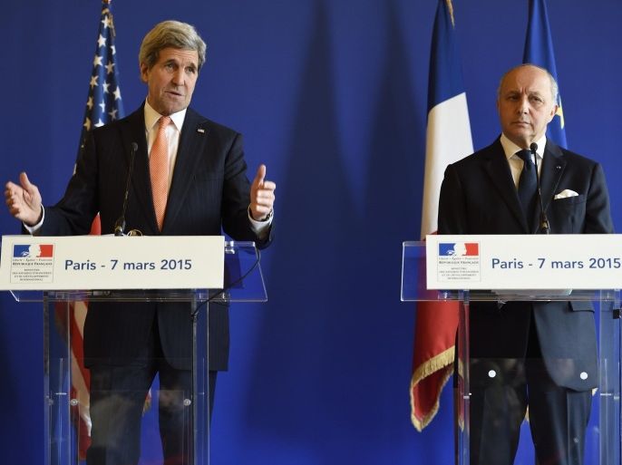 French Foreign Affairs Minister Laurent Fabius (R) listens on as US Secretary of State John Kerry speaks during a joint press conference on March 7, 2015 at the Foreign Affairs Minister in Paris. Kerry had flown into Paris just a couple of hours earlier in a bid to shore up European support for the proposed deal with Iran ahead of a March 31 deadline. AFP PHOTO /ERIC FEFERBERG