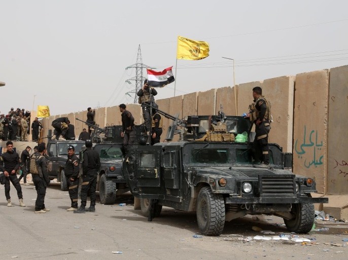 Iraqi security forces and allied Shiite militiamen gather at in Tikrit, 130 kilometers (80 miles) north of Baghdad, Iraq, Friday, March 13, 2015. Iraqi forces entered Tikrit for the first time on Wednesday from the north and south. On Friday, they fought fierce battles to secure the northern Tikrit neighborhood of Qadisiyya and lobbed mortars and rockets into the city center, still in the hands of IS. Iraqi military officials have said they expect to reach the center of Tikrit within two to three days. (AP Photo/Khalid Mohammed)