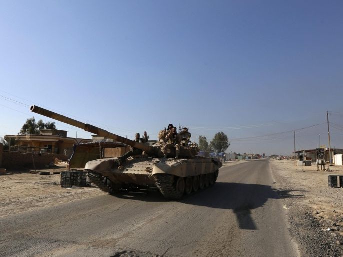 A tank of Iraqi security forces is seen in the town of al-Alam March 10, 2015. Iraqi troops and militias drove Islamic State insurgents out of al-Alam on Tuesday, clearing a final hurdle before a planned assault on Saddam Hussein's home city of Tikrit in their biggest offensive yet against the ultra-radical group. REUTERS/Thaier Al-Sudani (IRAQ - Tags: POLITICS CIVIL UNREST CONFLICT MILITARY)