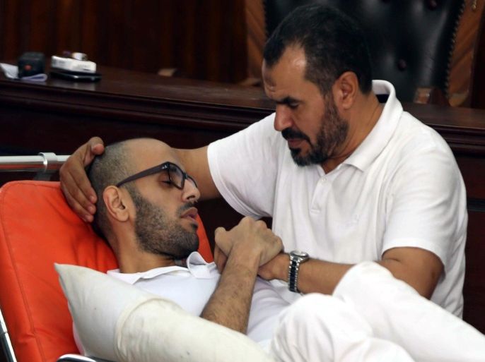 CAIRO, EGYPT - OCTOBER 15: Egyptian activist Mohammed Soltan (L), stages hunger strike for 263 days, meets with his father, well known Muslim Brotherhood official, Salah Soltan (R) on court hall before the trial that accuses him with 'misinforming the media' in Cairo, Egypt on October 15, 2014.