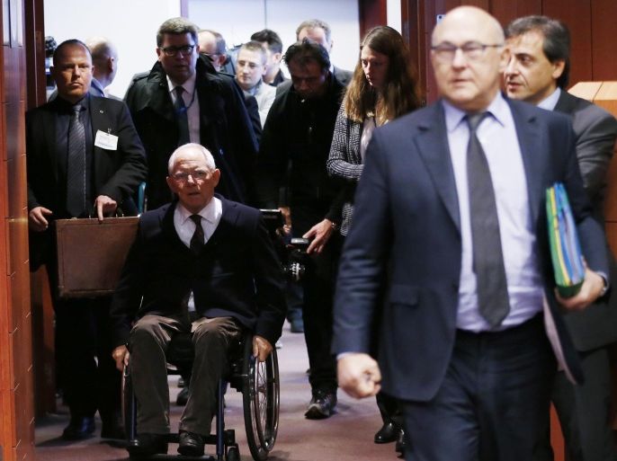 German Finance Minister Wolfgang Schaeuble and French counterpart Michel Sapin (R) arrive at an euro zone finance ministers meeting in Brussels February 16, 2015. Greece and its creditors made little progress in recent days toward an interim funding deal, officials involved in the talks said, citing wide differences over how the Athens government can deliver on election promises and satisfy lenders. REUTERS/Francois Lenoir (BELGIUM - Tags: POLITICS BUSINESS)