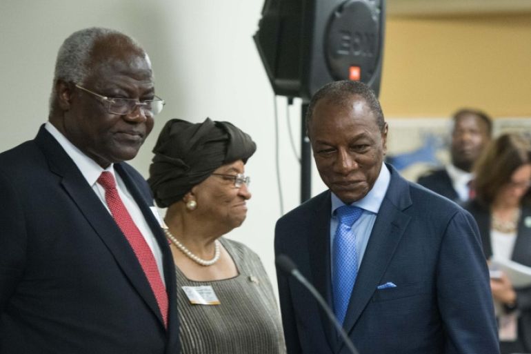 Guinean President Alpha Conde (R) walks past Sierra Leone President Ernest Bai Koroma (L) and Liberian President Ellen Johnson Sirleaf (C) to speak to the press following a meeting on the response to the Ebola crisis at the IMF/WB Spring Meetings in Washington, DC, on April 17, 2015. AFP PHOTO/NICHOLAS KAMM