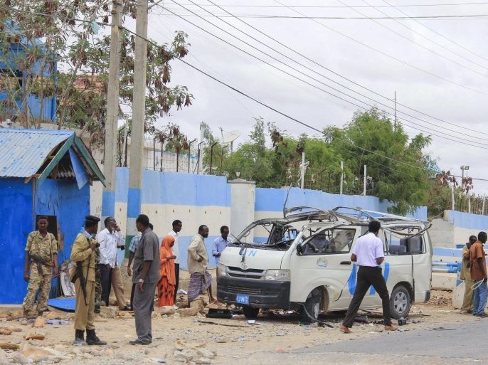 Security officers gather around a destroyed vehicle belonging to the United Nations in Garowe, the capital of Puntland, a semi-autonomous region of Somalia, 20 April 2015. According to reports, 10 people including the United Nations staffs died when a bomb went off on a vehicle carrying them. Somalia's Islamist militant group al-Shabab has claimed responsibility for the attack.